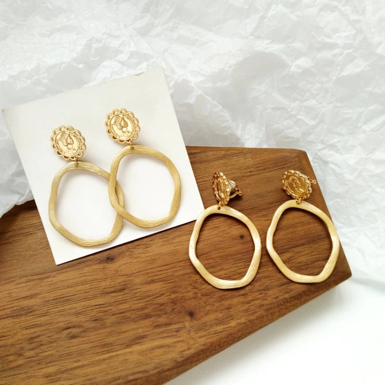Clip on 2 1/2" matte gold textured queen odd shaped hoop earrings