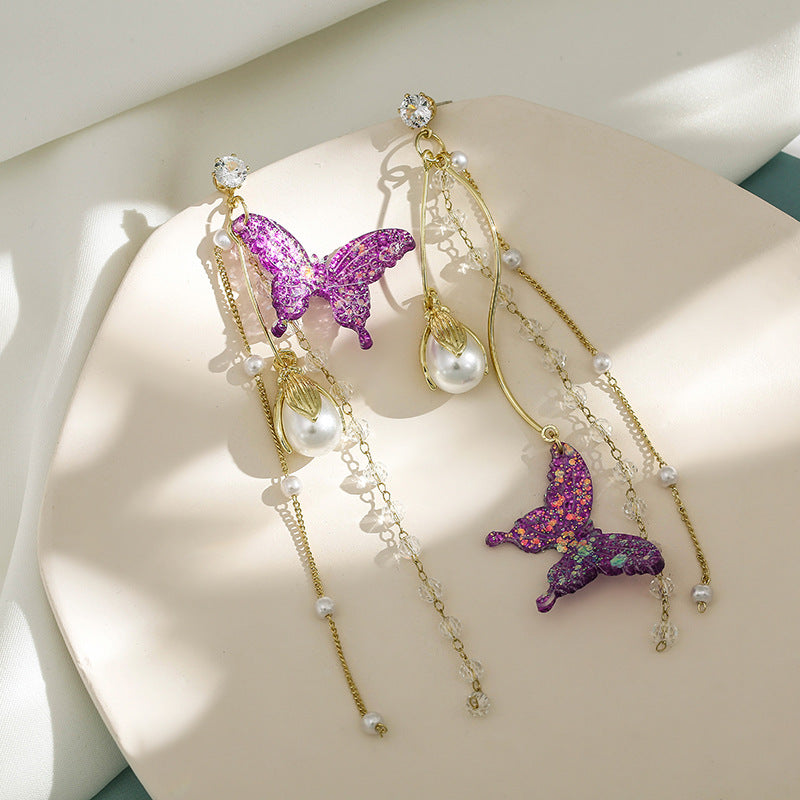 Clip on 4 3/4" gold high and low fluorescent glitter butterfly and pearl earrings