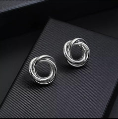 Clip on shiny and textured silver circle knot button earrings