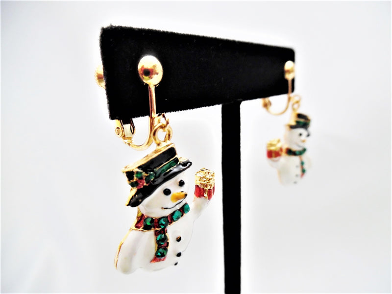 Clip on 1 1/2" gold, white and black dangle snowman earrings with broom
