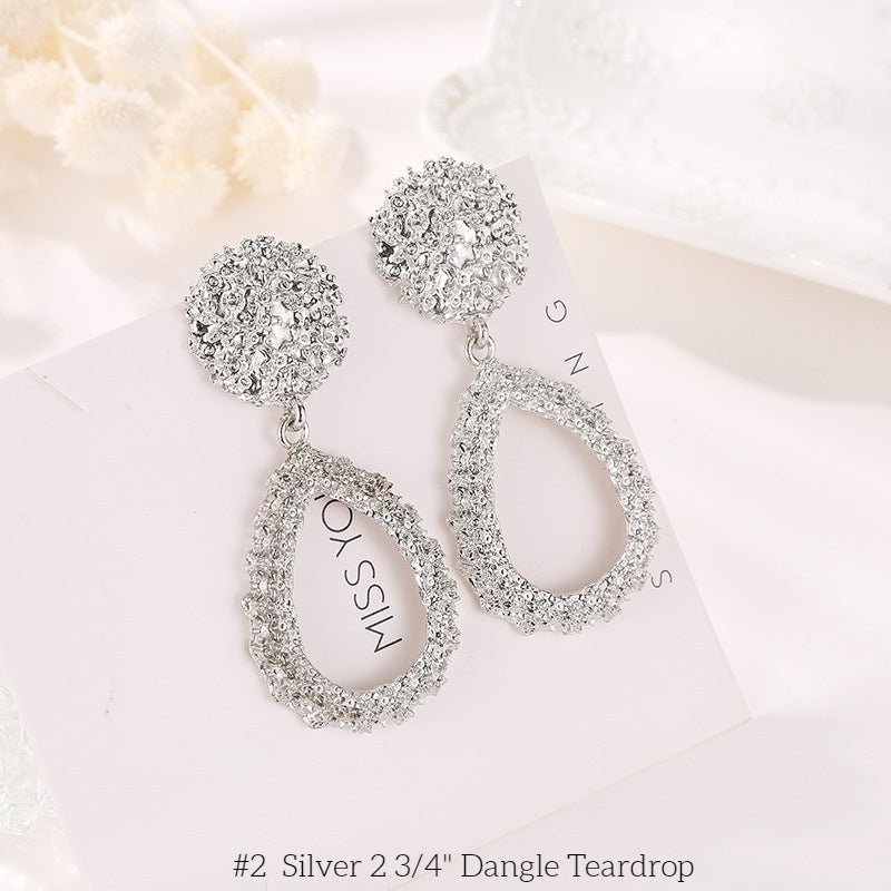 Clip on 2 3/4" silver textured dangle teardrop earrings